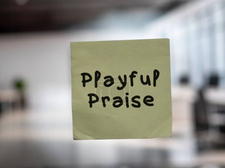 Post note on glass with 'Playful Praise'.