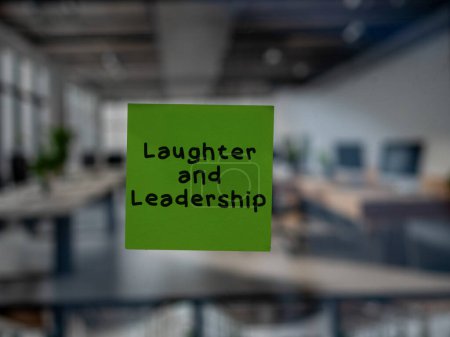 Post note on glass with 'Laughter and Leadership'.