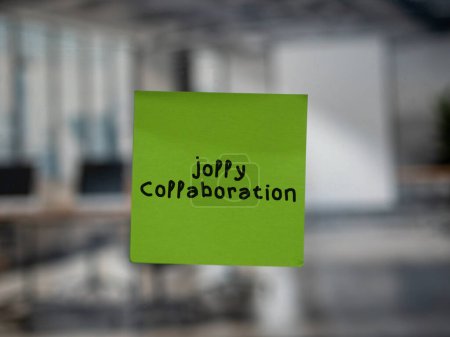 Post note on glass with 'Jolly Collaboration'.