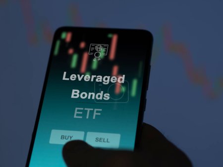 An investor analyzing the leveraged bonds etf fund on a screen. A phone shows the prices of Leveraged Bonds
