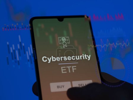 Ein Anleger analysiert den Cybersecurity-ETF-Fonds auf einem Bildschirm. Ein Telefon zeigt die Preise von Cybersecurity