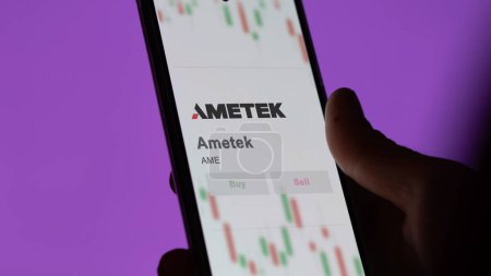 Photo for April 04th 2024. The logo of Ametek on the screen of an exchange. Ametek price stocks, $AME on a device. - Royalty Free Image