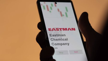 Photo for April 04th 2024. The logo of Eastman Chemical Company on the screen of an exchange. Eastman Chemical Company price stocks, $EMN on a device. - Royalty Free Image