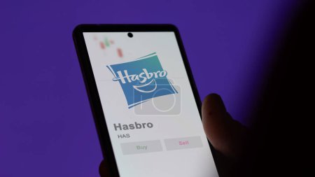 Photo for April 04th 2024. The logo of Hasbro on the screen of an exchange. Hasbro price stocks, $HAS on a device. - Royalty Free Image