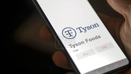Photo for April 04th 2024. The logo of Tyson Foods on the screen of an exchange. Tyson Foods price stocks, $TSN on a device. - Royalty Free Image