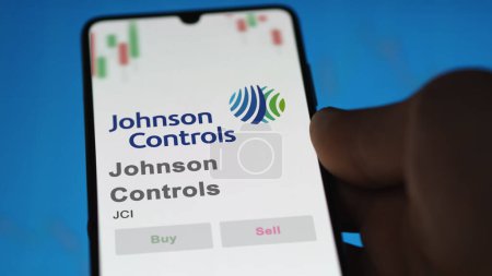 Photo for April 09th 2024 , Cork, Ireland. Close up on logo of Johnson Controls on the screen of an exchange. Johnson Controls price stocks, $JCI on a device. - Royalty Free Image