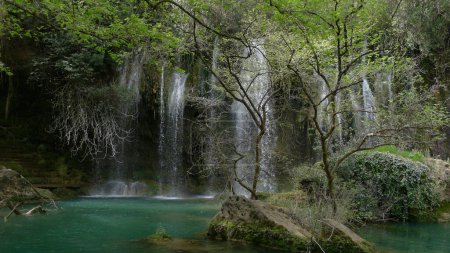 A beautiful Kurunlu Waterfall (Turkish: Kurunlu elalesi) is located 19 km from Antalya, Turkeysurrounded by lush green trees and a crystal-clear pool of water at its base.