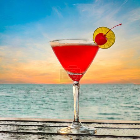 Photo for Pink lady, strawberry margarita, Sex on the beach or Pink negroni cocktails on the bar, in the resort, on the island, during the sunset The glass is garnished with lemon and cherry. - Royalty Free Image