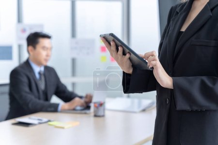 Photo for Portrait of an Asian businesswoman in a company office There are coworkers working in the background. - Royalty Free Image