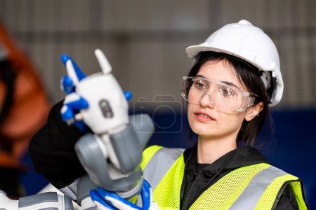 Photo for A team of male and female engineers meeting to inspect computer-controlled steel welding robots. Plan for rehearsals and installation for use. - Royalty Free Image