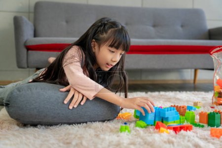 Photo for Asian girl pictures Playing block puzzle games at home together having fun and happiness. - Royalty Free Image