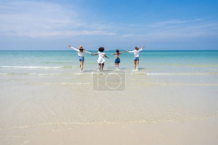 Photo for Photo of a group of girls of different ethnicities running and having fun together at the beach. on a fresh day - Royalty Free Image