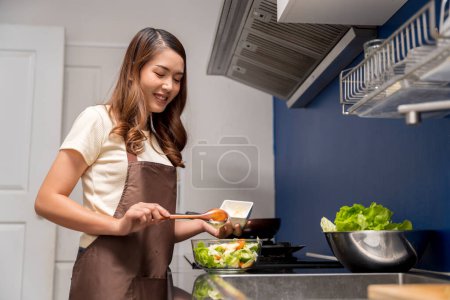 Photo for Asian woman making healthy food salad To take care health eat food that are beneficial to body Do it with cleanliness such as washing your hand before doing symptoms washing vegetables before eating - Royalty Free Image