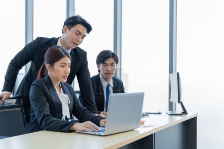 Photo for A group of young Asian businessmen Talking and planning work happily and have fun. at the company's office - Royalty Free Image