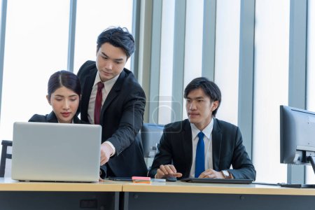 Photo for A group of young Asian businessmen Talking and planning work happily and have fun. at the company's office - Royalty Free Image