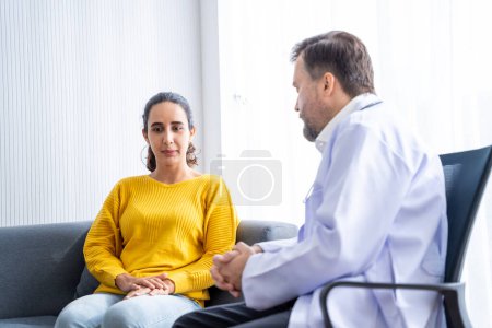 Photo for Male  doctor and Female patient Talk and give advice about the illnesses of patients in the hospital - Royalty Free Image