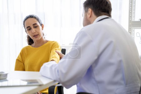 Photo for Male  doctor and Female patient Talk and give advice about the illnesses of patients in the hospital - Royalty Free Image