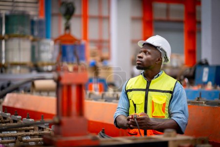 Photo for Young male engineer in metal sheet factory Responsible work is being inspected at the actual work site. Work professionally and happily - Royalty Free Image
