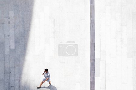 Photo for Top aerial view man people walk on across pedestrian concrete with black silhouette shadow on ground, concept of social still life. - Royalty Free Image