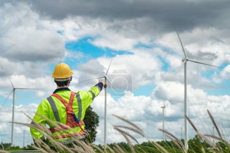 Photo for Engineer working in fieldwork outdoor. Technicians of wind turbine checking and maintenance Electricity wind generator.. operation of wind turbines that converts wind energy into electrical energy - Royalty Free Image