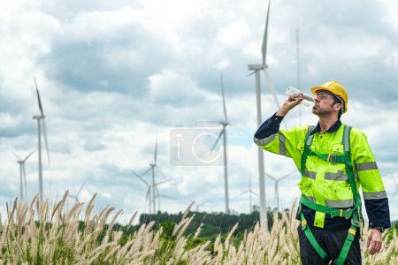 Photo for Engineer working in fieldwork outdoor. Technicians of wind turbine checking and maintenance Electricity wind generator.. operation of wind turbines that converts wind energy into electrical energy - Royalty Free Image