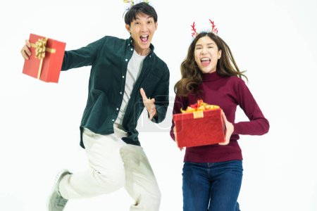 Photo for Young Asian couple two friends man woman wearing casual clothes  and holding present red box with gifts together isolated on white background studio portrait. concept new year and christmas gifts. - Royalty Free Image