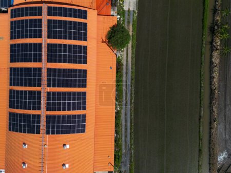 Téléchargez les photos : Vue aérienne supérieure du système de toit solaire sur le toit de l'entrepôt d'usine. énergies renouvelables photovoltaïques pour réduire l'empreinte énergétique et carbone. énergie propre. panneau solaire et structure au bâtiment. - en image libre de droit