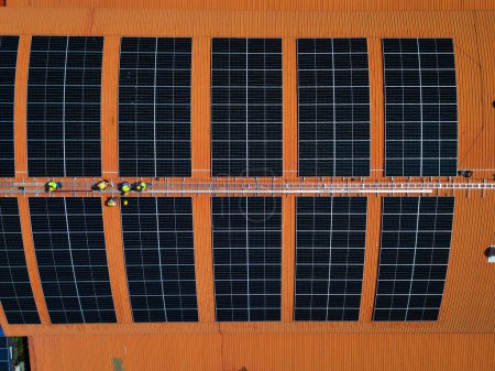 Photo for Top aerial view of solar roof system at the rooftop of factory warehouse. renewable energy of photovoltaic for reduce energy and carbon footprint. clean energy. solar panel and structure at building. - Royalty Free Image
