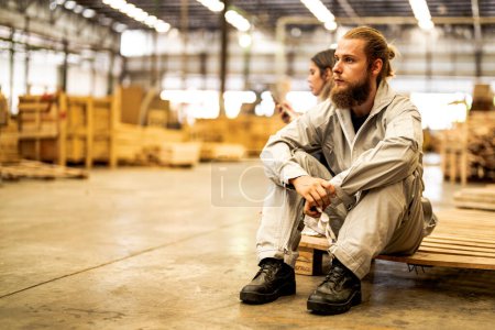 Photo for Man workers engineering sitting with confidence with working suite dress and hand glove in front machine. Concept of smart industry worker operating. Wood factory produce wood palate. - Royalty Free Image
