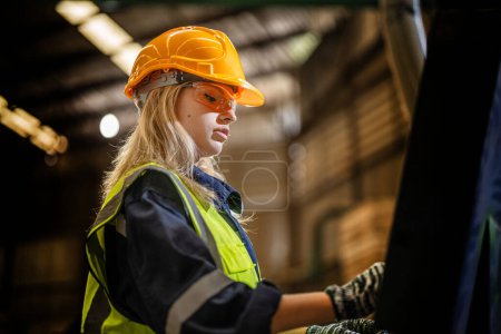 Photo for Factory engineer woman standing confidence to control panel switch. Worker works at heavy machine at industry factory. with machinery equipment plant technology. smart industry worker operating. - Royalty Free Image