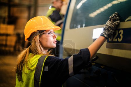 Photo for Factory engineer woman standing confidence to control panel switch. Worker works at heavy machine at industry factory. with machinery equipment plant technology. smart industry worker operating. - Royalty Free Image