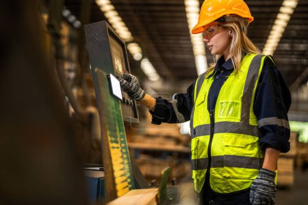 Photo for Factory engineer woman standing confident to control panel switch. Worker works at heavy machine at industry factory. worker checking timber of raw wood material. smart industry worker operating. - Royalty Free Image