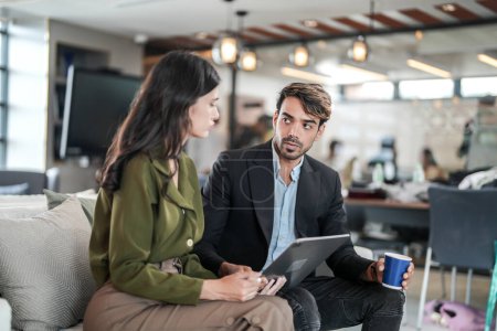 Photo for Business people talking at workplace office. Male and female colleagues enjoy relaxing and sitting on sofa. colleagues discussing about the project in the office. team of young people in office. - Royalty Free Image