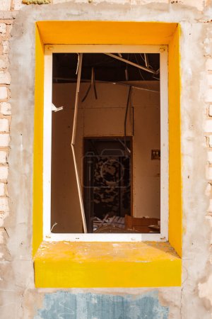 close-up rectangular window without glass in a cafe destroyed by a Russian bomb