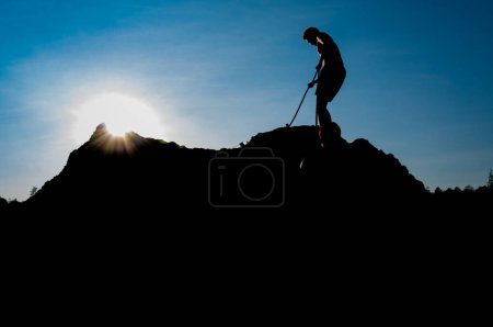 Photo for Climber on sunset sky background - Royalty Free Image