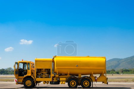 Photo for Yellow truck with fuel tank on runway - Royalty Free Image