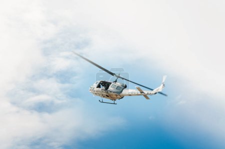 Photo for Helicopter in flight, blue sky background - Royalty Free Image