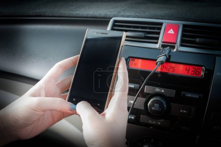 Photo for Hand hold smartphone in car,People press the phone while driving - Royalty Free Image