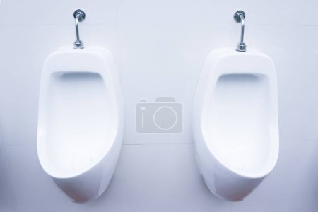 Photo for Men's room urinals discharge of waste from the body,clean toilet - Royalty Free Image