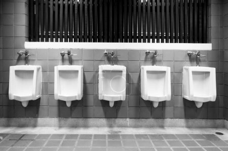 Photo for Men's room urinals discharge of waste from the body,men toilets white and black - Royalty Free Image