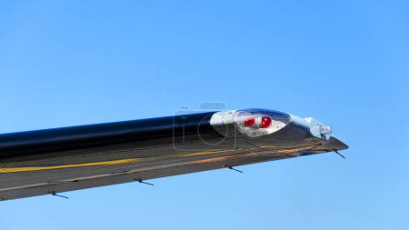 Photo for Position light on the wing of the plane, Red navigation light on left wing of jet airplane. - Royalty Free Image
