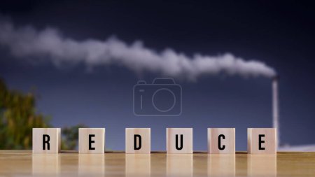 Photo for Icons related to reduce on wooden blocks, factory, industry, smoke, cigarette smoke emissions on background, bad ecology, environment ozone air low carbon footprint production concept. - Royalty Free Image