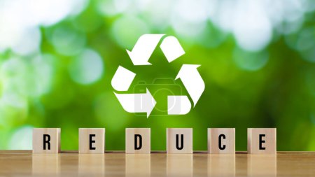 Photo for Icons related to reduce, on green background with wooden blocks the concept of reduce, reuse, recycle symbols, ecological waste management and sustainable and economical lifestyles. - Royalty Free Image