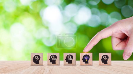 Thinking skills for business leader and manager concept. creative, systematic thinking skill, Hand business picked wooden cube block with head human symbol and light bulb icon creative idea concept.