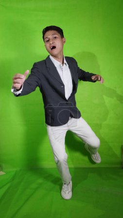 Photo for The young Asian man with a look of pleasure and shock, as if he wanted to fly and fall - Royalty Free Image