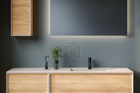 Photo for Close up chic bathroom with oval sink, empty countertop, wooden vanity, black-framed mirror, flower and blue wall. Ideal for showcasing your products in a stylish and modern setting. - Royalty Free Image