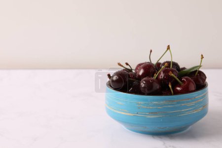 Photo for Fresh cherries with green leaf on a wooden background - Royalty Free Image