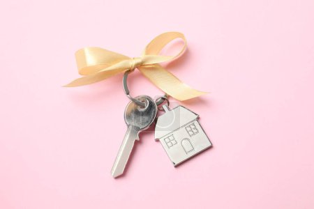 House key with golden bow on white background