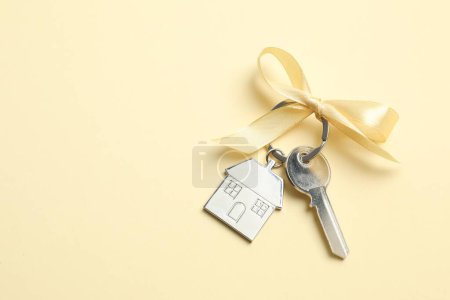 House key with golden bow on white background