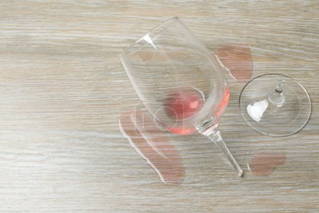 Photo for Glass of wine broken on the table - Royalty Free Image